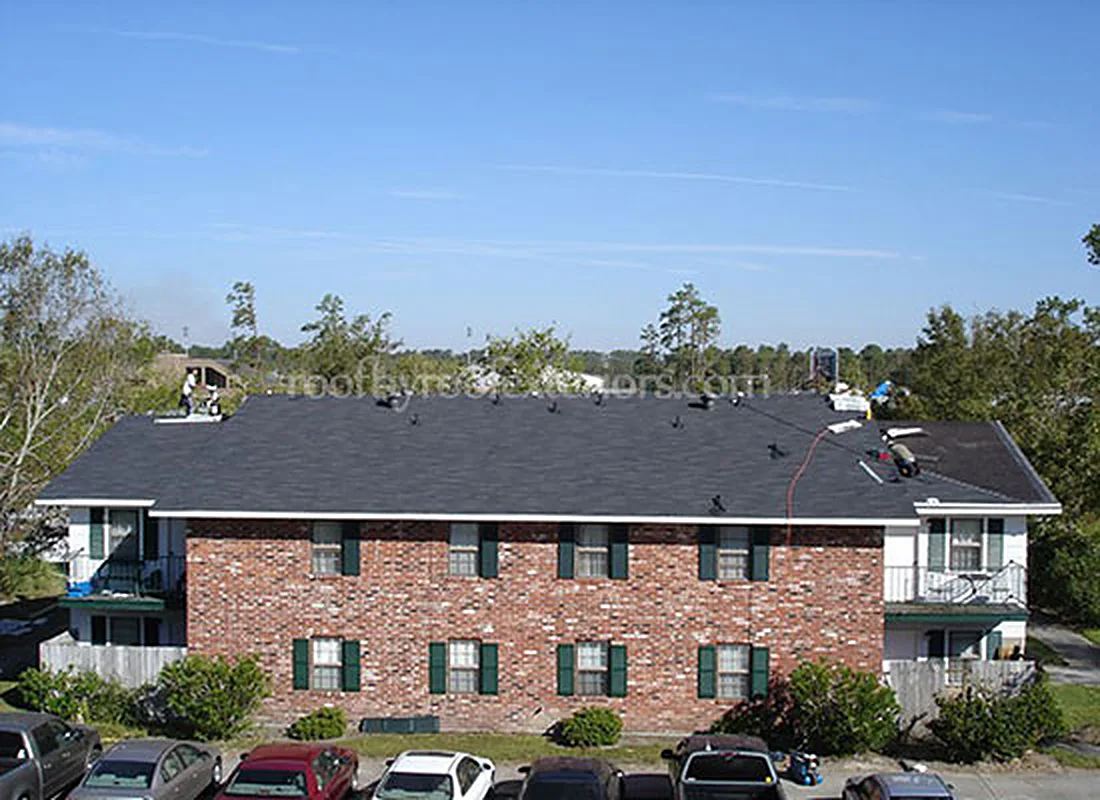 Brick apartment building with a newly finished grey roof