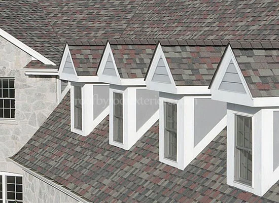 Row of gable dormers with white trim and eavestroughs