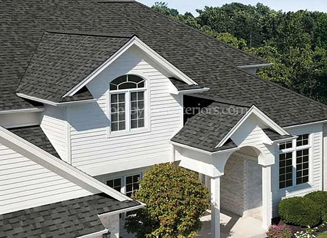 Two-storey home with a new charcoal shingle roof and multiple dormers